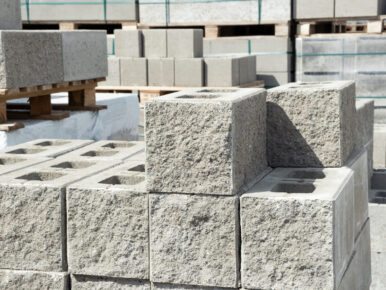 Stack of cement concrete Building cinder blocks brick  on pallete in hardware store with decorative stone texture side